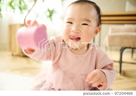 Baby playing in the living room Baby playing in the living room 97204466