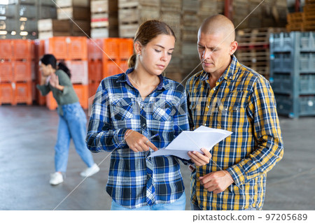 Man and young woman talking about documentation 97205689