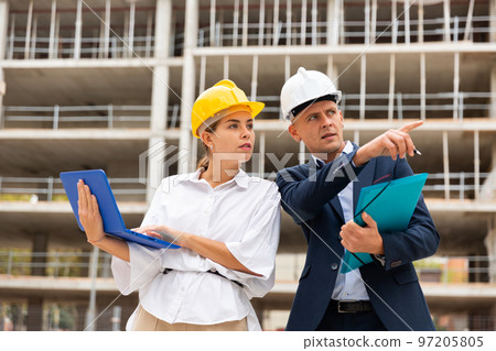 Man and woman engineers planning project of new building 97205805