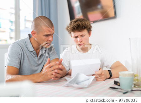 Father reassures his son after reading letter from college Father reassures his son after reading letter from college 97206035