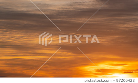 Western sky and clouds at dusk in late autumn shining in golden color Wide 16:9 97206428