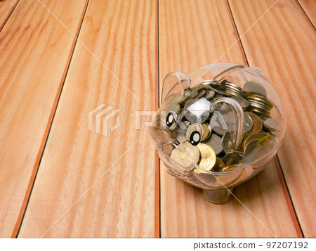 The piggy bank on wood table for earn or saving concept The piggy bank on wood table for earn or saving concept 97207192