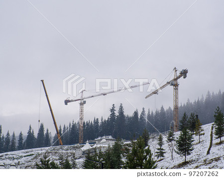 construction cranes among the mountains construction cranes among the mountains 97207262