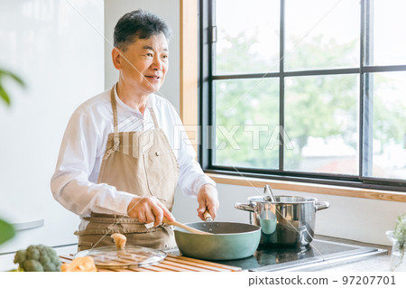 Elderly Asian man cooking homemade food using a frying pan in the kitchen at home (smile) Elderly Asian man cooking homemade food using a frying pan in the kitchen at home (smile) 97207701