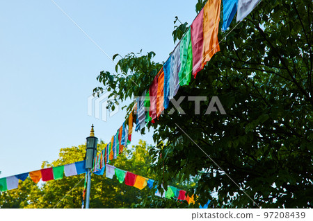 Prayer flags in all colors covering ropes in forest Prayer flags in all colors covering ropes in forest 97208439