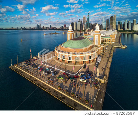 Vintage cars cover end of Navy Pier during morning light in Chicago with downtown skyline in background Vintage cars cover end of Navy Pier during morning light in Chicago with downtown skyline in background 97208597