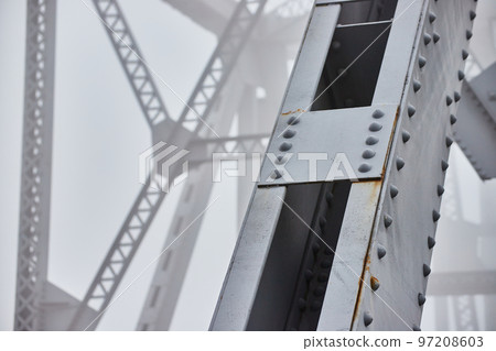 Foggy morning detail of steel beams bridge with soft background 97208603