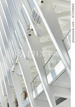 Clean modern architecture inside train station New York City white ribs going up with glass rails on upper floor Clean modern architecture inside train station New York City white ribs going up with glass rails on upper floor 97208660