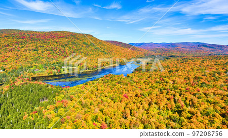 Lake tucked into colorful peak fall mountains in New York Lake tucked into colorful peak fall mountains in New York 97208756