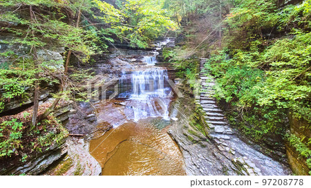 View over gorge with staircase and waterfall 97208778