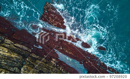 Tide pools off Maine coast from above with waves and rocks 97208920