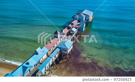 Shops cover large pier on ocean coast of Maine 97208925