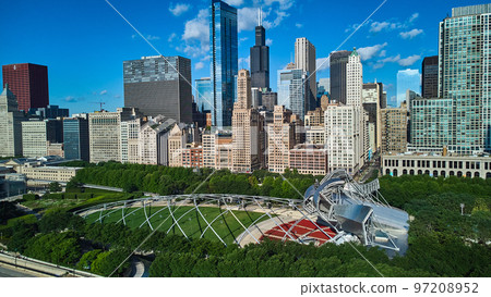 Pavilion in Millennium Park of Chicago next to line of large skyscrapers 97208952