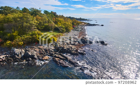 Patch of Maine coastline from above with rocky edge and green forest Patch of Maine coastline from above with rocky edge and green forest 97208962
