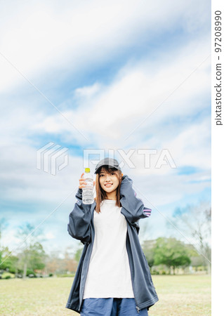 Woman rehydrating after exercising 97208990