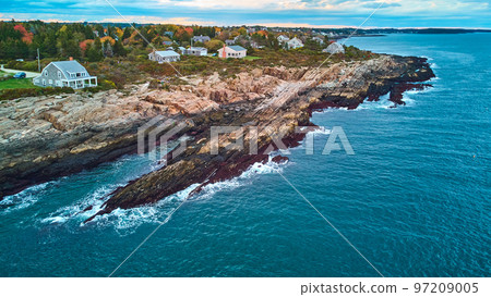 Aerial of coast of Maine with rocky cliffs, houses, and ocean waves crashing Aerial of coast of Maine with rocky cliffs, houses, and ocean waves crashing 97209005