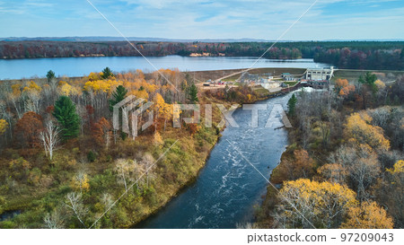 Muted fall colors in late fall aerial over Michigan river and lake with dam Muted fall colors in late fall aerial over Michigan river and lake with dam 97209043