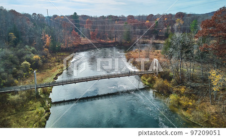 Late fall vibes aerial at suspension bridge over river in Michigan Late fall vibes aerial at suspension bridge over river in Michigan 97209051