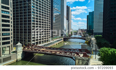 View down row of bridges through the Chicago ship canal surrounded by skyscrapers View down row of bridges through the Chicago ship canal surrounded by skyscrapers 97209093