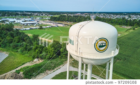 Aerial of Huntertown, Indiana water tower utility with farming and Allen County Fairgrounds in background 97209108