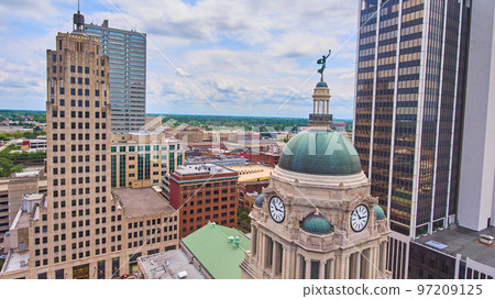 City surrounds top of Fort Wayne Indiana courthouse from aerial City surrounds top of Fort Wayne Indiana courthouse from aerial 97209125