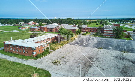 Aerial over huge abandoned brick hospital in Indiana 97209128