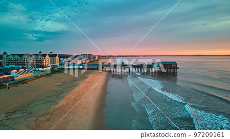 Aerial view over beach in Maine during sunrise with town and old wood pier of shops 97209161