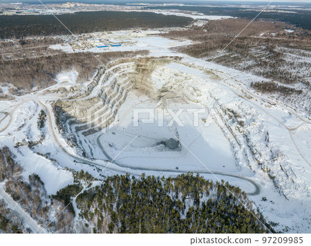 Aerial view to crushed stone quarry in winter with snow. Aerial view to crushed stone quarry in winter with snow. 97209985