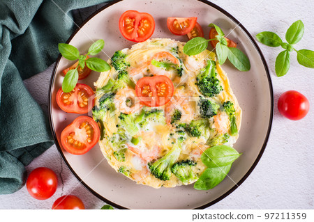 Omelet with broccoli and shrimp on a plate on the table. Homemade Protein Meal. Top view. Closeup Omelet with broccoli and shrimp on a plate on the table. Homemade Protein Meal. Top view. Closeup 97211359