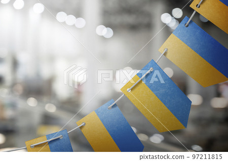 A garland of Ukraine national flags on an abstract blurred background 97211815