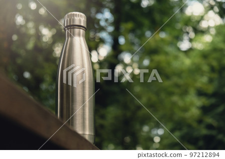 Water bottle. Reusable steel thermo water bottle on wooden bench isometric concept. Sustainable lifestyle. Plastic free zero waste free living. Go green Environment protection 97212894