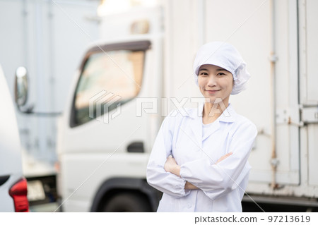 Young female food delivery driver (arms folded) 97213619