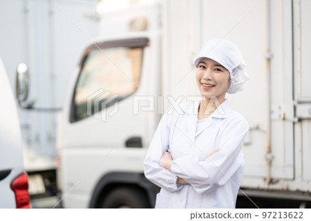 Young female food delivery driver (arms folded) 97213622