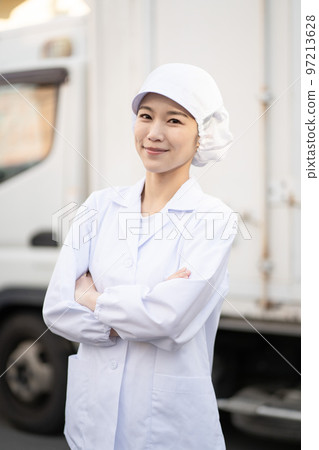 Young female food delivery driver (arms folded) 97213628