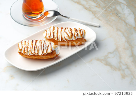 Eclairs with cream decorating of Swiss meringue frosting Eclairs with cream decorating of Swiss meringue frosting 97213925