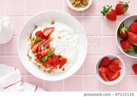 Yogurt with strawberry. Plain white greek yogurt with fresh berries and granola. Healthy food, breakfast. Top view 97215119