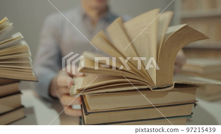 book close-up flipping pages. man reading a book in the library. education bookstore concept. university book turn pages slow motion video. bookstore hands men reading close-up lifestyle a book 97215439