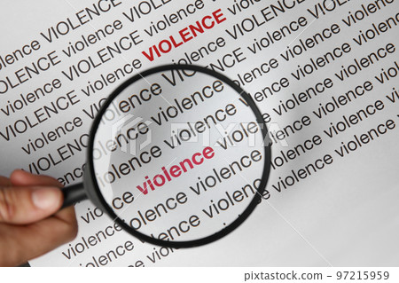 Woman holding magnifying glass over sheet of paper with words VIOLENCE, closeup Woman holding magnifying glass over sheet of paper with words VIOLENCE, closeup 97215959