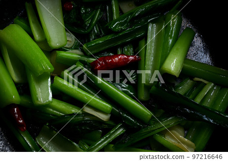 Stir-fried greens being cooked 97216646