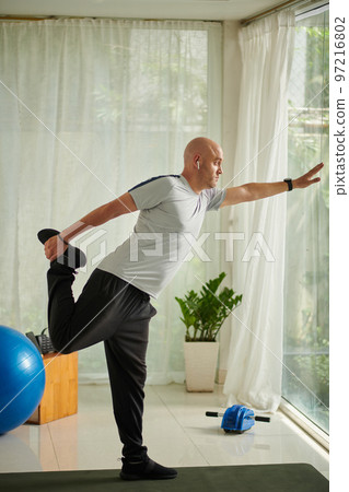 Mature man working out at home in the morning 97216802