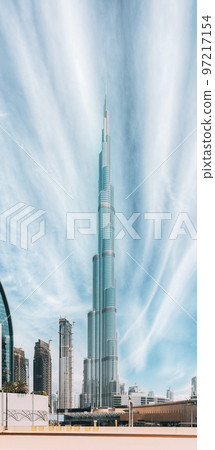 View of Burj Khalifa against clear sky. View of landmarks of residential district in Dubai Marina. Burj Khalifa, known as the Burj Dubai with a total height of 828 m. Vertical photo View of Burj Khalifa against clear sky. View of landmarks of residential district in Dubai Marina. Burj Khalifa, known as the Burj Dubai with a total height of 828 m. Vertical photo 97217154