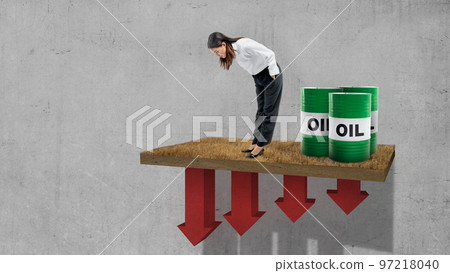 Asian businesswoman looking down with an oil barrel Asian businesswoman looking down with an oil barrel 97218040