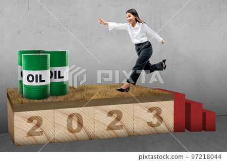 Asian businesswoman running with 2023 and an oil barrel Asian businesswoman running with 2023 and an oil barrel 97218044