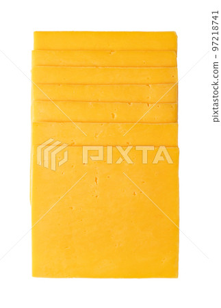 Stack of cheddar cheese slices, sliced natural cheese, sharp-tasting and colored orange with annatto, a natural food coloring. Close-up, from above, isolated on white background, macro food photo. 97218741