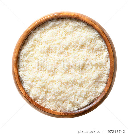 Grated Grana Padano cheese, in a wooden bowl. Italian hard cheese, similar to Parmesan, with strong savory flavor and slightly gritty texture, made from unpasteurized cow milk. Used for pasta dishes. 97218742