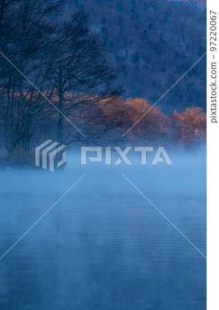 Lake at dawn with morning mist. Lake Kussharo in Hokkaido Lake at dawn with morning mist. Lake Kussharo in Hokkaido 97220067
