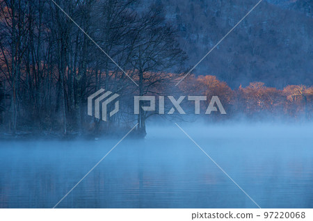 Lake at dawn with morning mist. Lake Kussharo in Hokkaido Lake at dawn with morning mist. Lake Kussharo in Hokkaido 97220068