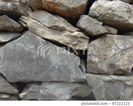 Background from rock texture close-up. The wall of natural stone of gray and brown. Background from rock texture close-up. The wall of natural stone of gray and brown. 97222123