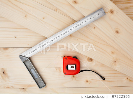 A measuring tape and a square. 97222595