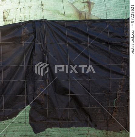 Metal wire fence and synthetic fabric. 97222621